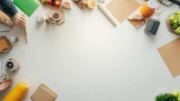 Top view of people working at a table with food and other items photo