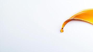 Orange liquid flowing over a white surface photo