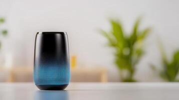 A blue and black speaker sitting on a table photo