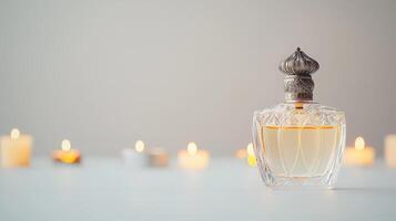 A perfume bottle with candles in the background photo