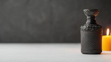 A candle and a bottle of perfume on a table photo