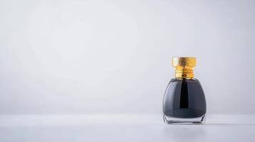 A bottle of black perfume sitting on a table photo