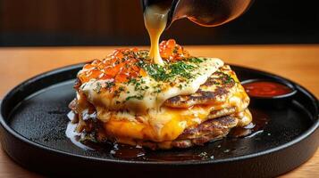 A plate with a stack of pancakes on top of it photo
