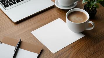 A cup of coffee and a notebook on a wooden desk photo
