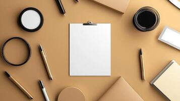 A white clipboard surrounded by various office supplies photo