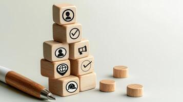 A wooden block with icons and a pen photo