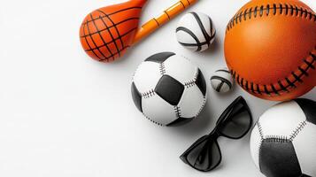 Various sports equipment including a basketball, soccer ball, and sunglasses photo