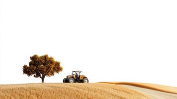 A tractor driving through a field with a tree photo