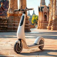 A white electric scooter parked in front of a temple photo