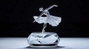 A crystal ballerina figurine on a glass base photo