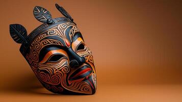 A tribal mask on a brown background photo