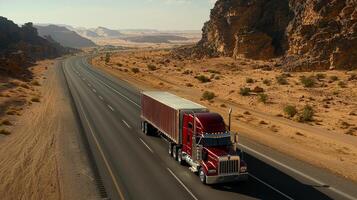 A red semi truck driving down a desert road photo