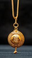 A gold pendant with an oriental design on it photo