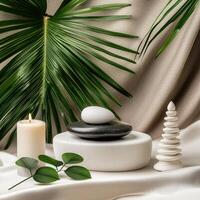 Spa stones, candles and palm leaves on a table photo