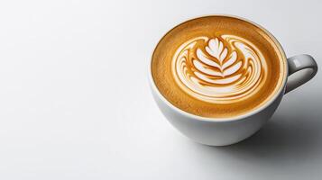 A cup of coffee with a leaf design on top photo