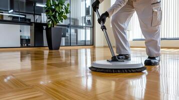 A person cleaning a wooden floor with a vacuum photo