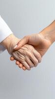 An elderly woman shaking hands with a doctor photo