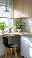 A small kitchen with a desk and chair photo