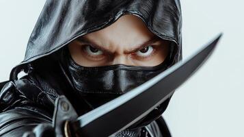 A man in a black hoodie with a knife photo