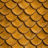 A close up of a gold metal wall with many different shapes photo