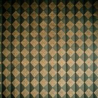 A green and gold checkered wall with a diamond pattern photo