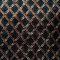 A dark blue and gold rug with a diamond pattern photo