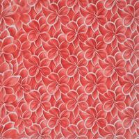 A red and white flower pattern on a fabric photo