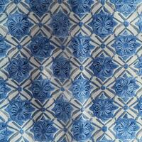 A blue and white patterned fabric with a flower design photo