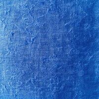 A blue painted canvas with a white background photo