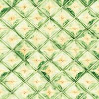 A green and yellow tile pattern with a diamond pattern photo