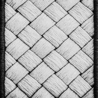 A black and white photo of a woven rug