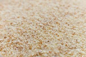 Close-up of raw semolina background in macro mode and soft focus photo