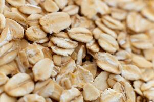 Close-up macro shot of raw oat flakes in shallow depth of field photo
