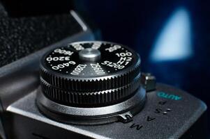 Shutter button on a retro film camera close-up. Modern digital camera made in retro style, close-up of the button that adjusts the shutter speed photo