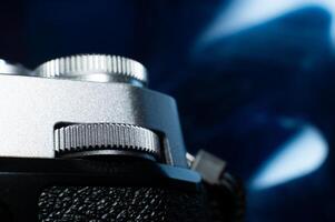 Close-up macro shot of retro style camera controls. Silver camera controls in soft focus photo