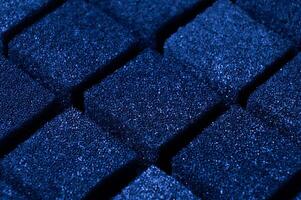 Blue Cubes of flexible foam sponges laid out in a pattern. Macro close-up in soft focus. Abstract cubic background photo