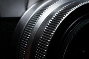 Macro photography of camera parts, featuring symmetry, texture and precision. Close-up of lens rings, ribbed surface photo