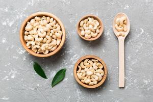 cashew nuts wooden bowl on table background. top view. Space for text photo