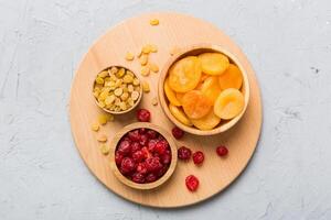 Bowl with different dried fruits on table background, Healthy lifestyle with copy space photo