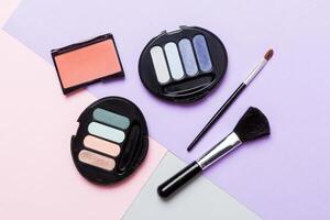 Professional makeup tools. lay. Beauty, decorative cosmetics. Makeup brushes set and color eyeshadow palette on table background. Minimalistic style photo