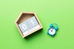March 1st. Image of March 1 wooden block calendar on colored background. Empty space for text photo