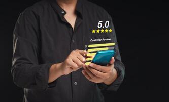 Satisfaction and feedback surveys. A businessman in a suit using a smartphone gives the five-star icon a rating of very impressed for service photo