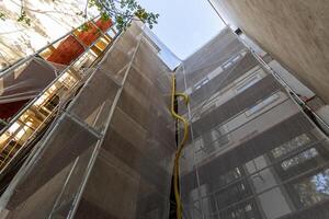 Scaffolding, facade of a multi-story building, reconstruction of the facade of the house. Vienna, Austria photo