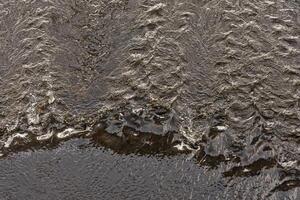The flow of water in the Elbe River near Dresden. View from above. Water background. photo