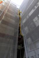 Scaffolding on the facade of a multi-story building, reconstruction of the facade of the house. Vienna, Austria photo