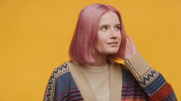Young Woman Listening Intently on Yellow Background video