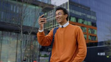 Happy student calling on campus video