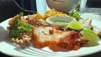 take a piece of fatty pork with a fork and dip it into the sauce video