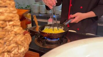 cook stirs egg making omelette scrabble egg Breaking Egg On Frying Pan. Egg falling on hot frying pan in slow motion. video