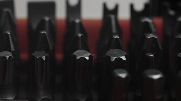 Close-up view of precision screwdriver bits arranged in a row, showcasing the sharp tips and detailed craftsmanship. video
